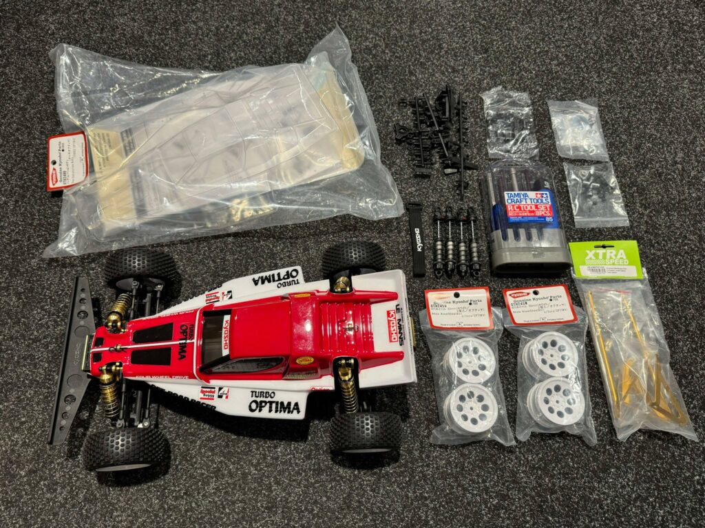 kyosho turbo optima 4wd + extra kyosho body + extra set luxe dempers + tamiya toolset + xtra speed tuning onderdelen + extra set velgen helemaal nieuw!